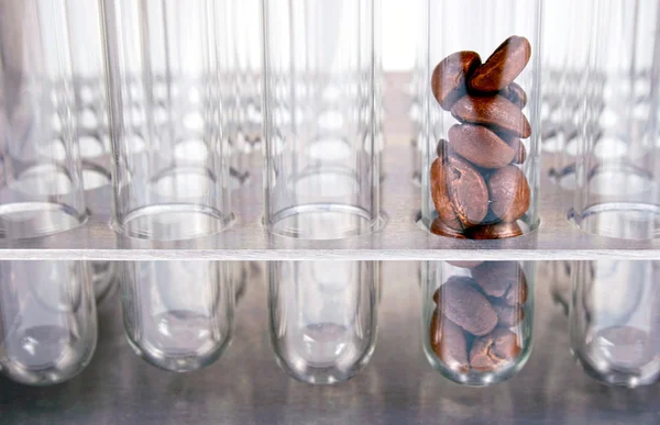 Test tube with coffe against empty test tubes — Stock Photo, Image