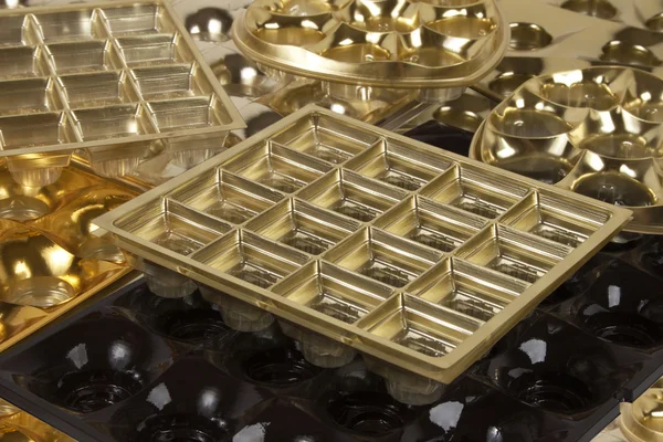 Çikolata şekiller arka plan boş altın kutular — Stok fotoğraf
