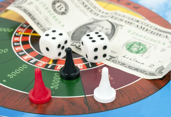 Cubes, counters and money on roulette background money — Stockfoto