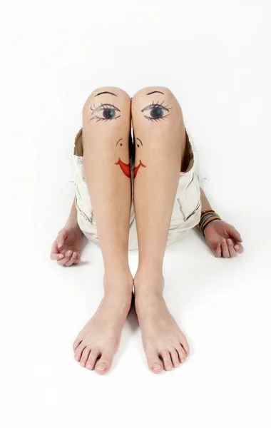 Knees with the drawn faces — Stock Photo, Image