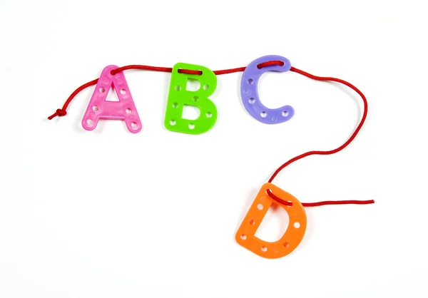 ABCD from color plastic on a cord — Stock Photo, Image