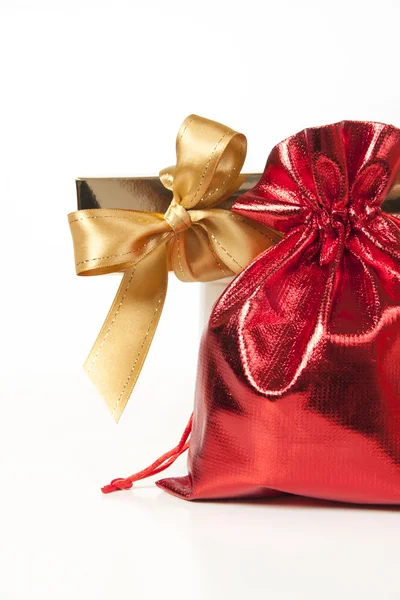 Red bag with gifts and a gold bow — Stock Photo, Image