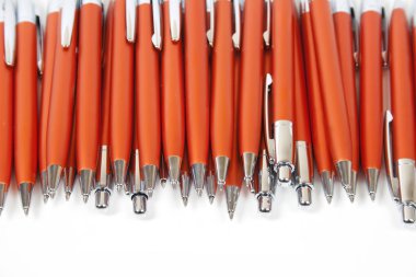 Many orange pens