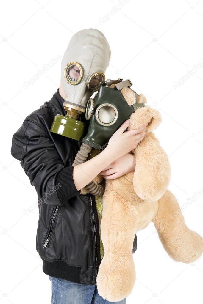 Child with a toy in gas mask