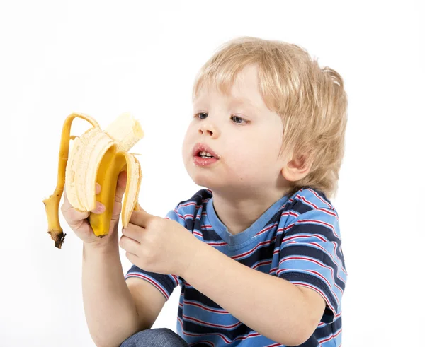 Сhild eats banana — Stock Photo, Image