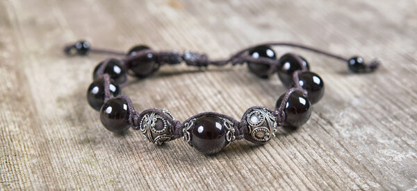 Popular Buddhist bracelet shamballa on a wooden background