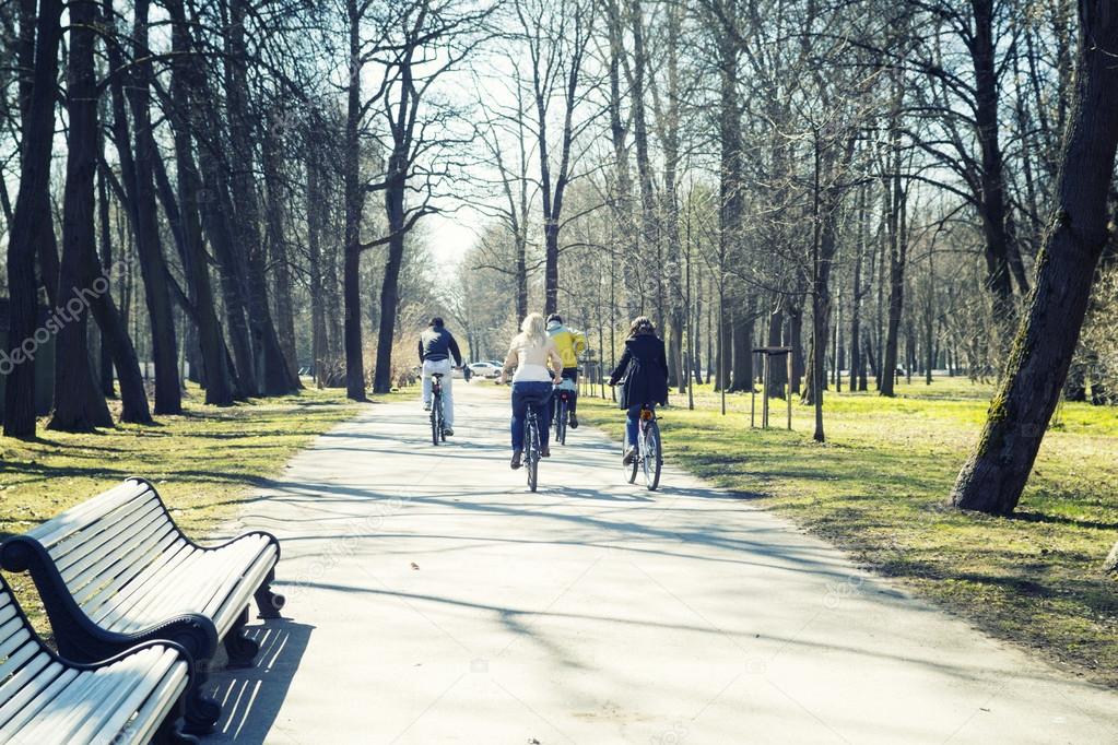 People ride bikes in park