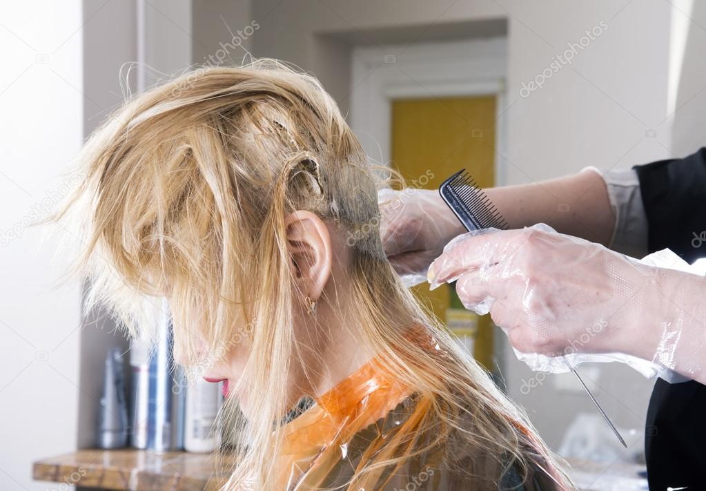 Hairdresser dyes hair