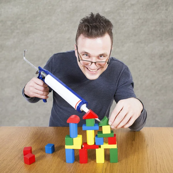 Man lijm huis van kubussen — Stockfoto