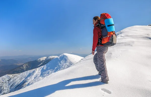 Пішохідна дівчина з рюкзаком у високих горах Стокова Картинка