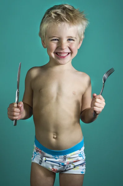 Niño con planchas para comer —  Fotos de Stock