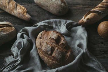 Freshly baked bread rustic wooden table background,. High quality photo