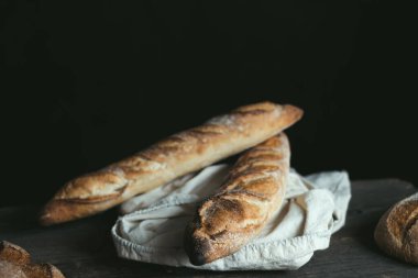 Buckwheat bread baguettes are packed in an eco bag on a wooden table. Low calorie nutritious product. Concept of healthy food and traditional baking. High quality photo