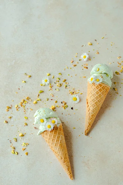 Pistachio Ice Cream Horn Decorated Chamomile Flowers Scattered Nuts Summer — Stock Photo, Image