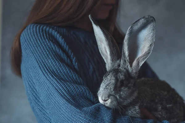 A sad girl with a rabbit. Friendship with an animal. . High quality photo