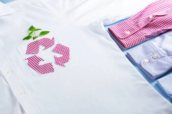 Textile Recycle. Checkered clothing recycling symbol on white shirt mockup. Ecological and sustainable fashion industry.