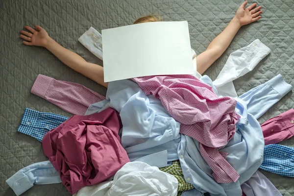 A big pile of clothes child with outstretched arms and closed face empty blank form for text. Recycling of clothes. Ecological and sustainable lifestyle. High quality photo