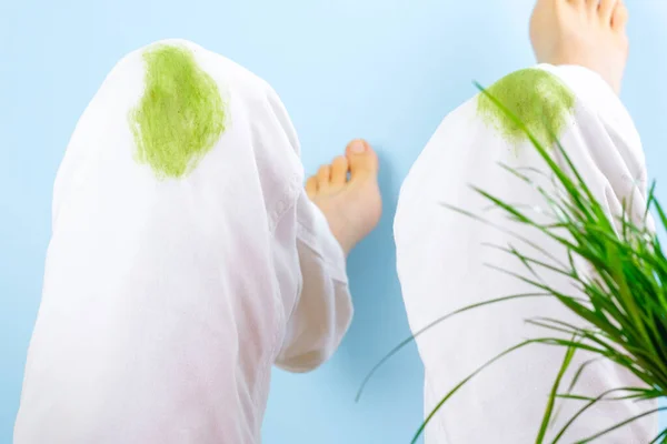 Dirty grass stains on clothes.on a blue background. green spots on the knees of the pants. spoiled clothes. isolated. High quality photo