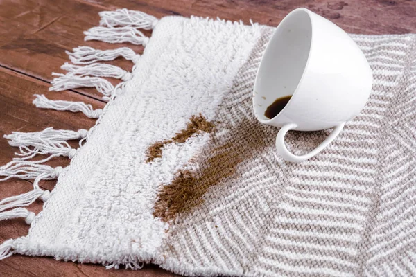 Coffee spilling from cup on carpet. Domestic life. The concept of cleaning stains. High quality photo