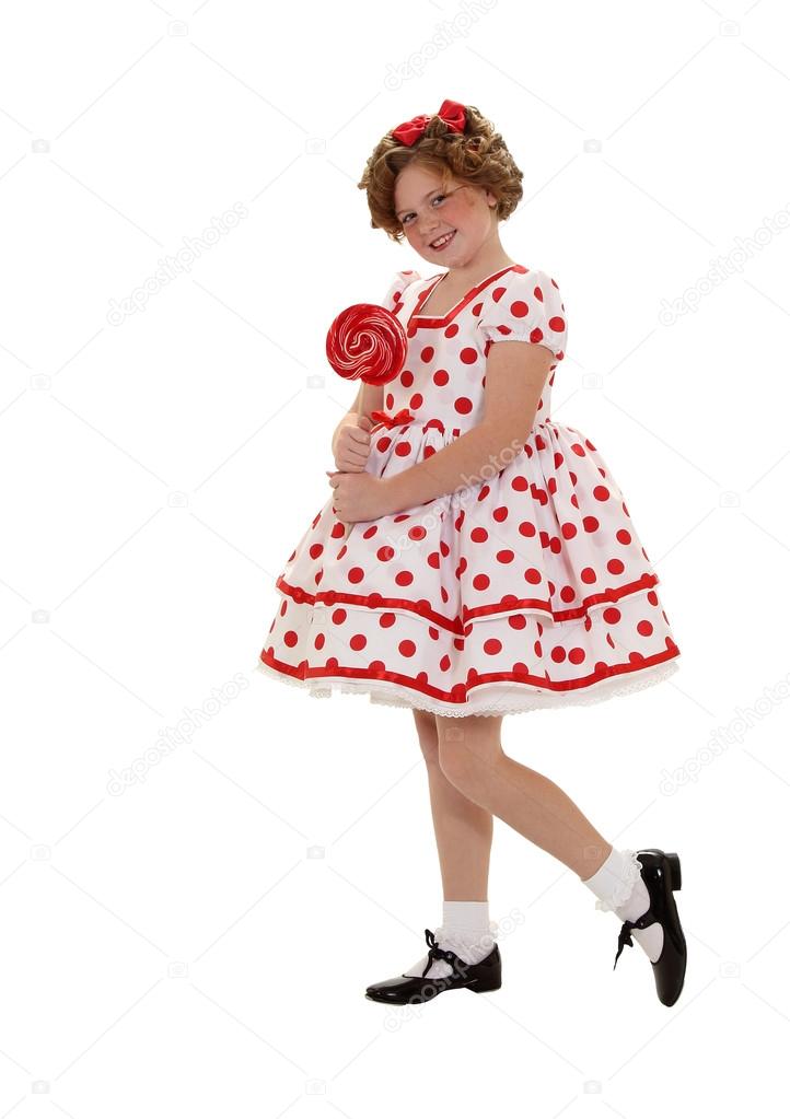Standing in a Polka Dot Dreass Holding a Lollipop
