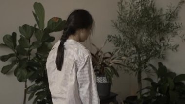 Beautiful Asian young woman shaking her head and pigtail, looks unhappy, lost due to unpleasant thoughts. Beauty suffers from lifes problems. Filmed in cinematic style