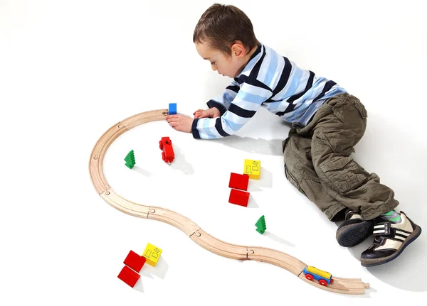 Boy playing with a train set — Stock Photo, Image