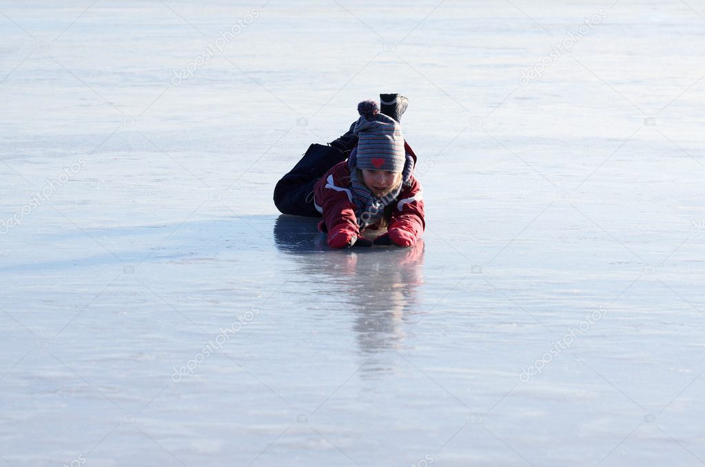 The girl fall down on the ice