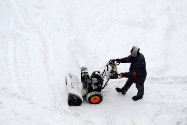 Man pushing snow blower clipart
