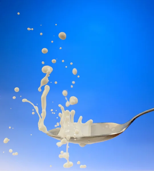 Splash of the milk on the spoon — Stock Photo, Image