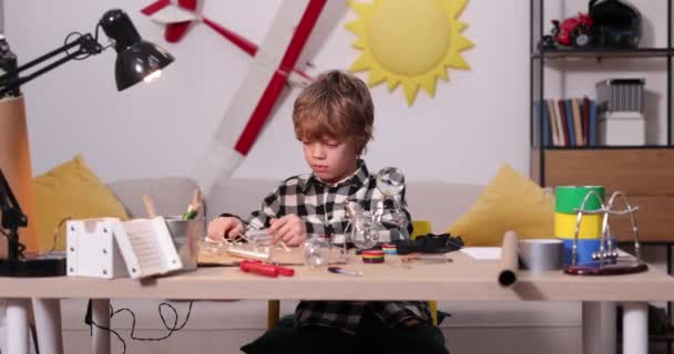 Genç mühendis. Elektronik konusunda tutkulu bir çocuk. Küçük çocuk. Çocuklar için icatlar ve yaratıcılık. Tamirat, eğitim faaliyetleri konsepti. — Stok video