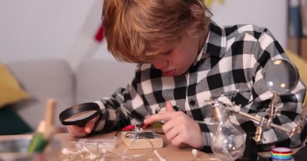 Young engineer. Boy passionate about electronics. DIY kid. Inventions and creativity for kids. Tinkering, educational activities concept. — Stock Video