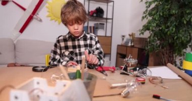 Genç mühendis. Elektronik konusunda tutkulu bir çocuk. Küçük çocuk. Çocuklar için icatlar ve yaratıcılık. Tamirat, eğitim faaliyetleri konsepti.