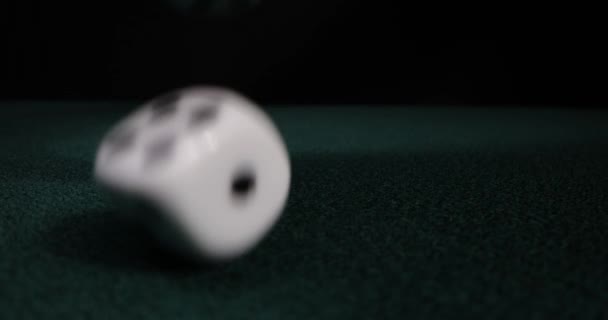 Rolling dice in slow motion. Dices falling to green table. Gambling and casino concept — Stock Video