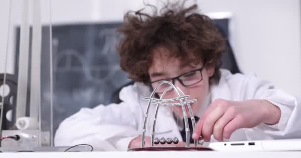 Schoolboy experimenting in physics class. Young student doing physics experiment in the classroom. — Stock Video