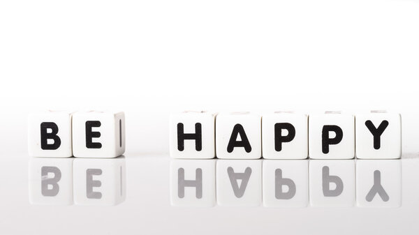 Be Happy spelled in black letters reflected on white background