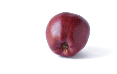 A fresh dark red apple is highlighted on a white background. copy space