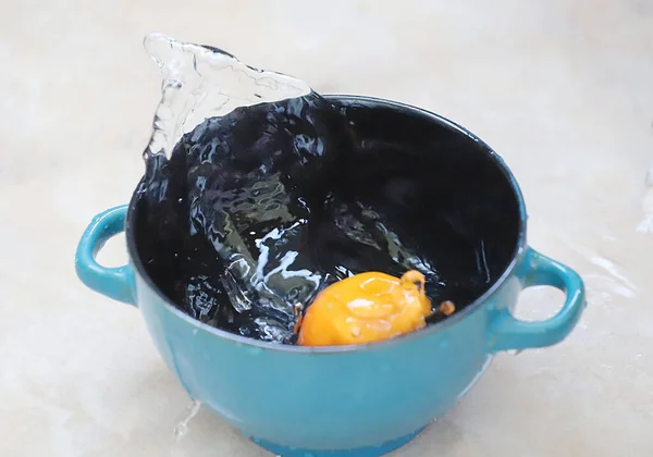 Ckoseup Picture Blue Ceramic Bowl Apricot Splashed Water Outdoor Shot — Stock Photo, Image