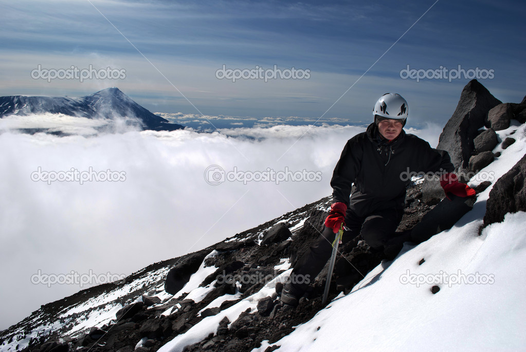 hiker on mountain with peak on fog