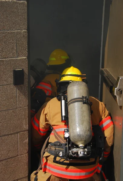 Firefigher and smoke — Stock Photo, Image