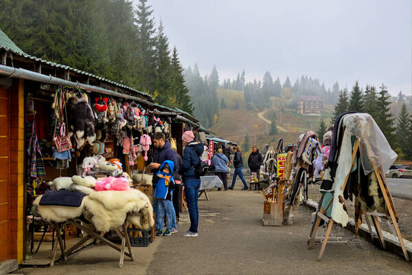 Yablunytsya pass, Ivano-Frankivsk oblast, Ukraine - October 29, 2020: Open Air Traditional Crafts Fair. National Ukrainian products. The long counters display a variety of handicrafts.