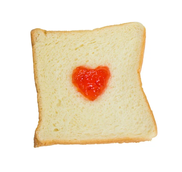 Dżem kształcie serca na kawałek chleba. — Zdjęcie stockowe