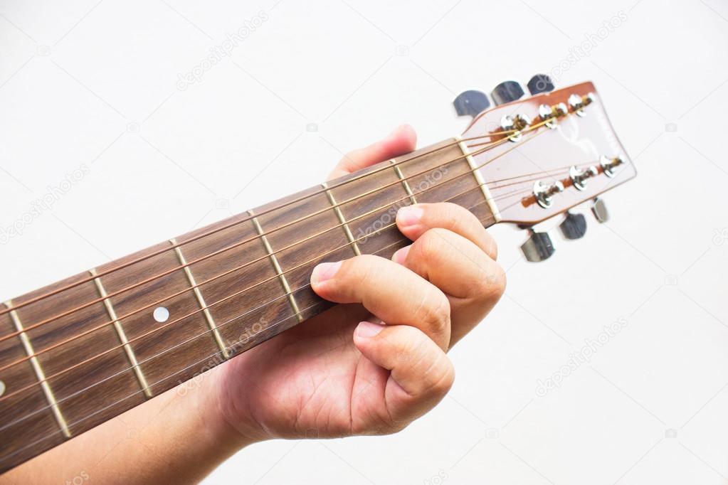The guitarist show the D chord on the guitar isolated on white b