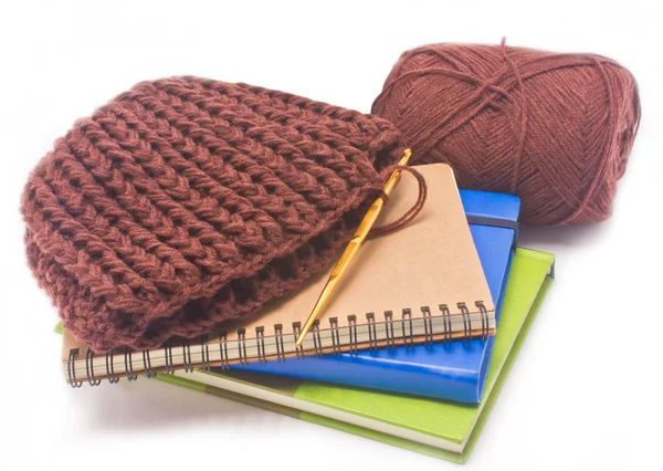 Brown crochet hat with golden hook, yarns and books isolated on — Stock Photo, Image