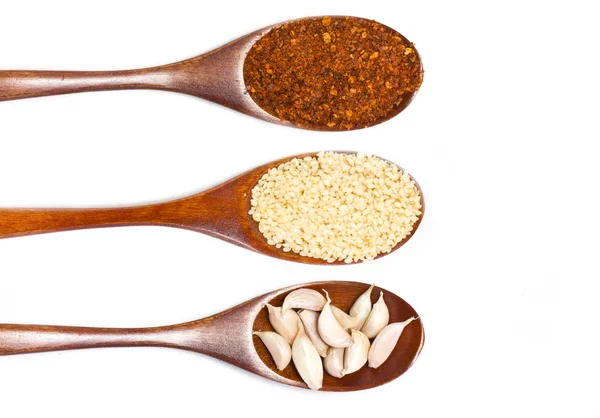 Sesame seeds on wooden spoon isolated on white background. — Stock Photo, Image