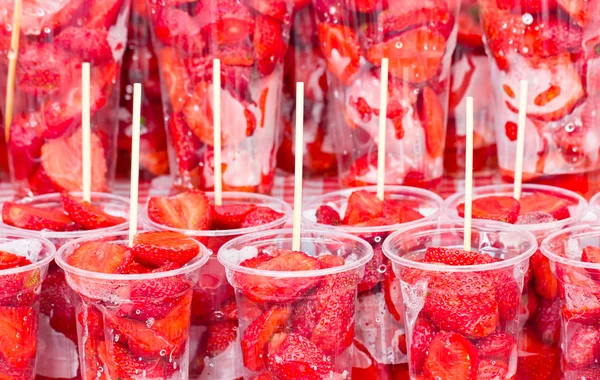 Fresh strawberry in transparent plastic glasses. — Stock Photo, Image