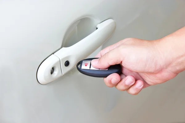 Hand holding a car's remote control — Stock Photo, Image