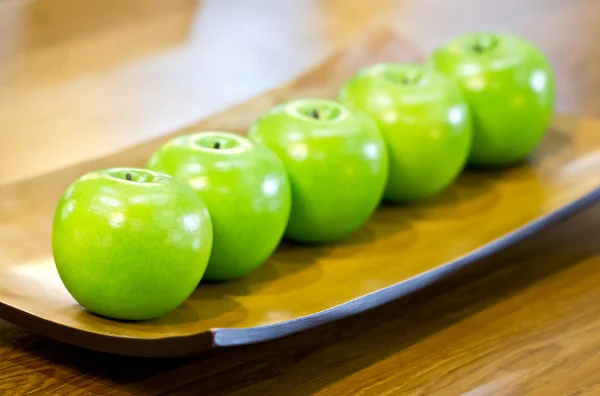 Plastic green apples on plate. — Stock Photo, Image