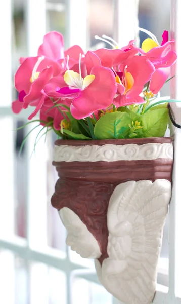 Artificial flowers in clay pot. — Stock Photo, Image