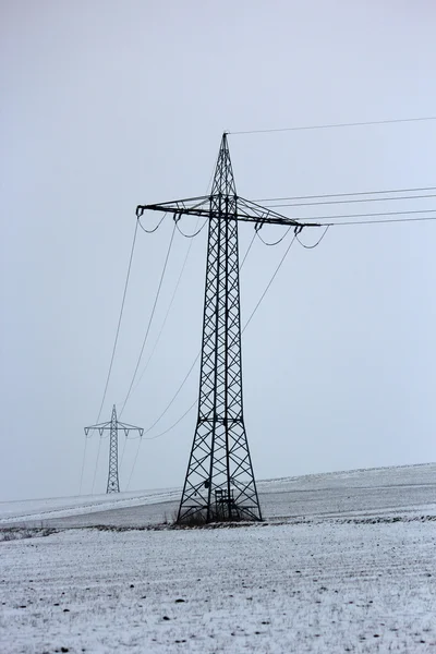 Electricity pylon in winter — Stock Photo, Image