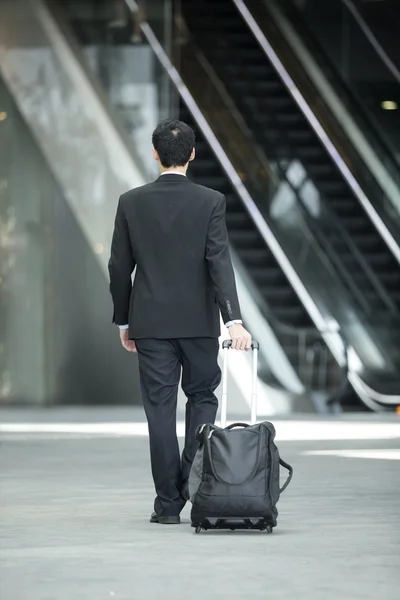 Chinese Business man walking and using a Cell Phone